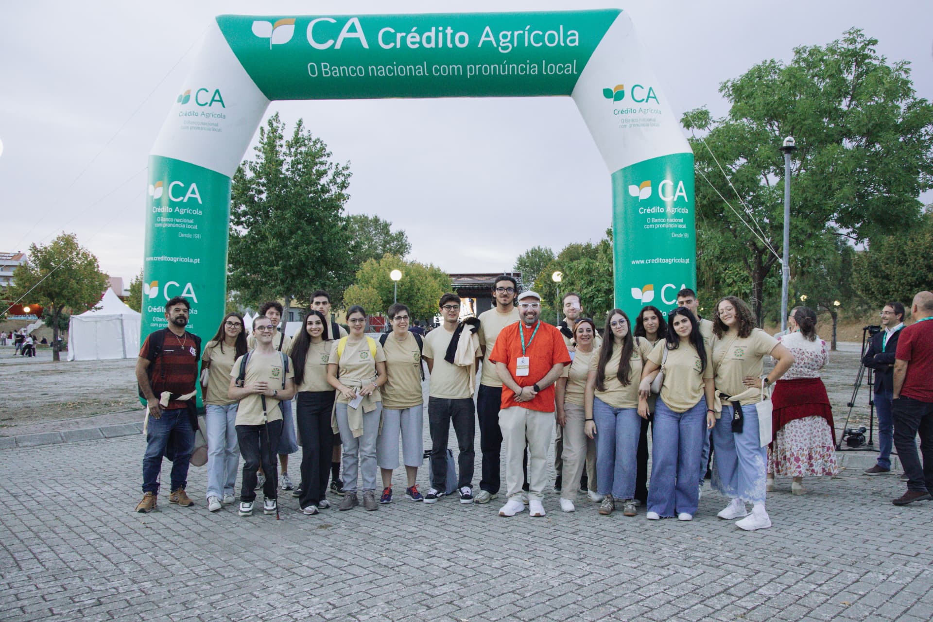 Grupo de participantes posa sob o arco insuflável de entrada